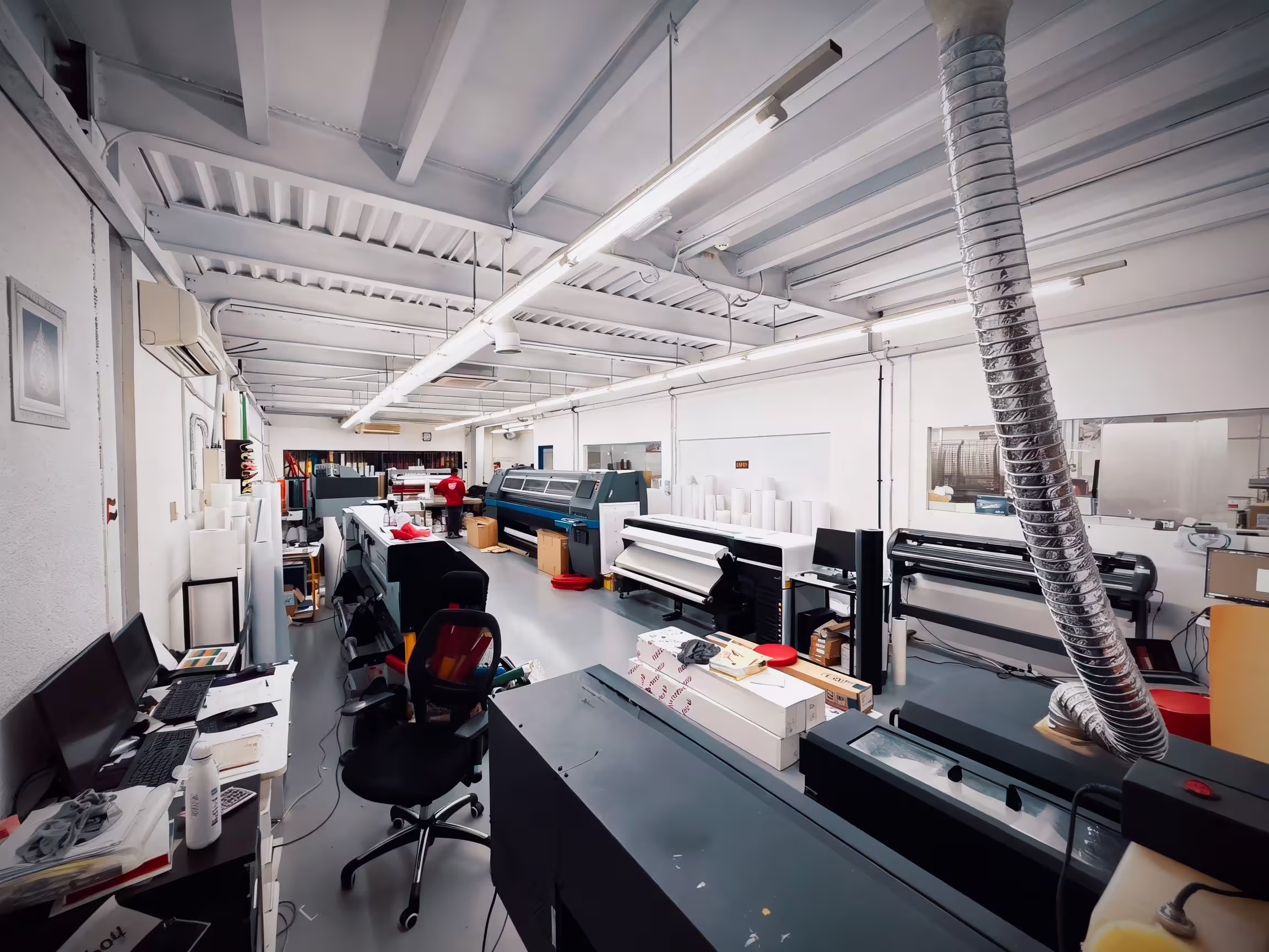 Creative team workspace with digital design stations and color sample wall for print projects