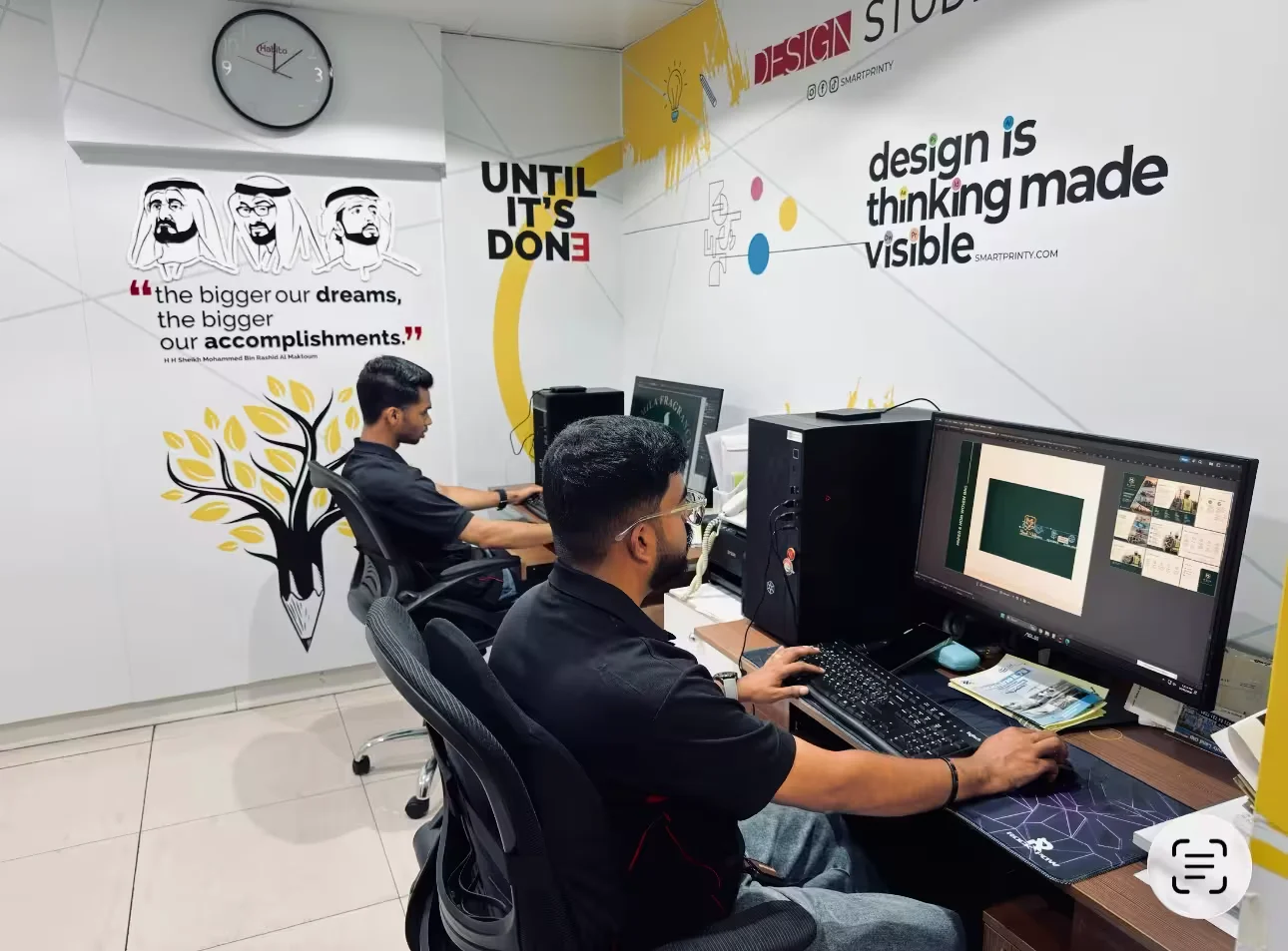 Modern printing facility with open-plan design studio and large format production equipment in Dubai
